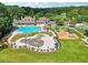 Aerial view of a resort-style pool and splashpad surrounded by lush landscaping and playground area at 3595 Millwater Xing, Dacula, GA 30019