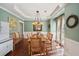 Inviting dining room with tray ceiling, wood floors, and stylish decor at 3595 Millwater Xing, Dacula, GA 30019
