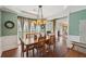 Elegant dining room with tray ceiling, wood floors, and stylish decor at 3595 Millwater Xing, Dacula, GA 30019
