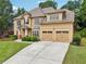 Charming two-story home featuring a manicured lawn, beautiful landscaping, and a welcoming front entrance at 3595 Millwater Xing, Dacula, GA 30019