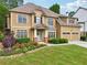 Charming two-story home featuring a manicured lawn, beautiful landscaping, and a welcoming front entrance at 3595 Millwater Xing, Dacula, GA 30019