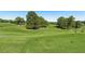 Beautiful view of the rolling green hills and fairways of the golf course on a sunny day at 3595 Millwater Xing, Dacula, GA 30019