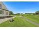 Landscaped golf course view with bench seating near the home with pathway at 3595 Millwater Xing, Dacula, GA 30019