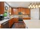 Kitchen features stainless steel appliances, wood cabinets, light countertops, and a central island at 3595 Millwater Xing, Dacula, GA 30019