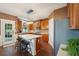 Kitchen with stainless steel appliances, light countertops, and wood cabinets with a central island and breakfast bar at 3595 Millwater Xing, Dacula, GA 30019
