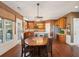 Well-lit kitchen with stainless steel appliances, wooden cabinets and countertops, and a unique wood dining table at 3595 Millwater Xing, Dacula, GA 30019