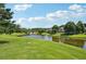 Tranquil lake view, framed by mature trees and manicured green spaces, offers serenity at 3595 Millwater Xing, Dacula, GA 30019