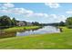 Picturesque lake view with beautiful homes nestled amongst mature trees on well maintained lawns at 3595 Millwater Xing, Dacula, GA 30019