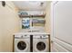 Functional laundry room with side by side washer and dryer and plenty of storage space at 3595 Millwater Xing, Dacula, GA 30019