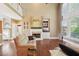 Spacious living room with a fireplace, built-in shelves, and large windows at 3595 Millwater Xing, Dacula, GA 30019
