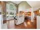 Bright living room with vaulted ceilings, fireplace, and open floor plan to the kitchen at 3595 Millwater Xing, Dacula, GA 30019