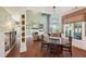 Spacious room featuring an open-concept area with a fireplace, shelves, wooden table and chairs at 3595 Millwater Xing, Dacula, GA 30019