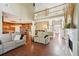 Open-concept living room featuring a fireplace and flows into the kitchen area at 3595 Millwater Xing, Dacula, GA 30019