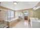 Bright bathroom with a glass shower, soaking tub, double sink vanity, and a linen closet at 3595 Millwater Xing, Dacula, GA 30019