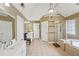 Large main bathroom with double sink vanity, soaking tub, and a glass enclosed shower at 3595 Millwater Xing, Dacula, GA 30019