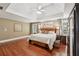 Spacious main bedroom with tray ceilings, hardwood floors, and a decorative wooden bed frame at 3595 Millwater Xing, Dacula, GA 30019