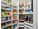 Walk-in pantry features custom shelving with plenty of room for storage at 3595 Millwater Xing, Dacula, GA 30019