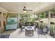 Inviting screened porch with comfortable seating and an outdoor stone fireplace at 3595 Millwater Xing, Dacula, GA 30019