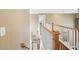 Traditional staircase with carpeted steps, a white banister and a varnished wood handrail at 3595 Millwater Xing, Dacula, GA 30019