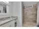 Bathroom with a tiled walk-in shower and granite topped vanity at 4670 Brookwood Dr, Cumming, GA 30041