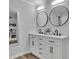 Bathroom featuring double sink vanity, modern fixtures, and stylish mirrors at 4670 Brookwood Dr, Cumming, GA 30041