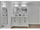 Bathroom featuring double sink vanity, modern fixtures, and stylish mirrors at 4670 Brookwood Dr, Cumming, GA 30041