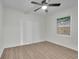 Bright bedroom featuring wood-look flooring, ceiling fan, and a window at 4670 Brookwood Dr, Cumming, GA 30041