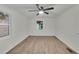 Bright bedroom featuring wood-look flooring, ceiling fan, and a window at 4670 Brookwood Dr, Cumming, GA 30041