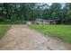 A view of the home with a detached garage, driveway and front lawn at 4670 Brookwood Dr, Cumming, GA 30041