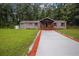 Charming brick home featuring a covered front porch, freshly painted driveway, and a well-maintained lawn at 4670 Brookwood Dr, Cumming, GA 30041