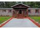 Inviting front porch with new landscaping and a modern walkway, enhancing curb appeal at 4670 Brookwood Dr, Cumming, GA 30041