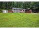 Spacious front yard showcasing a well-maintained lawn, a shed, and the side view of the home at 4670 Brookwood Dr, Cumming, GA 30041