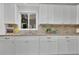 Well-lit kitchen with white cabinetry, granite countertops and a stylish backsplash at 4670 Brookwood Dr, Cumming, GA 30041