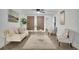 Bright living room featuring stylish decor, hardwood floors, a modern ceiling fan, and neutral tones at 4670 Brookwood Dr, Cumming, GA 30041