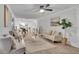 Open-concept living room with elegant furniture, hardwood floors, and seamless flow to the dining area at 4670 Brookwood Dr, Cumming, GA 30041