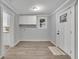 Entry room featuring white door, storage cabinets, and wood-look floors at 4670 Brookwood Dr, Cumming, GA 30041