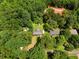 Aerial view of a property nestled among lush trees, offering privacy and a serene setting at 501 Samaritan Dr, Cumming, GA 30040