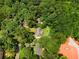 Drone shot featuring a home surrounded by mature trees providing shade and privacy from above at 501 Samaritan Dr, Cumming, GA 30040