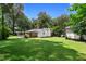 Large, private backyard with a shed and a screened-in porch, surrounded by mature trees at 501 Samaritan Dr, Cumming, GA 30040