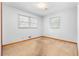 Bright bedroom with carpet, featuring two windows and neutral walls for personalization at 501 Samaritan Dr, Cumming, GA 30040