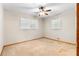 Sunny bedroom with two windows, ceiling fan, and carpet, perfect for a relaxing space at 501 Samaritan Dr, Cumming, GA 30040