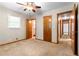 Bedroom with multiple doors, a ceiling fan, and natural light, offering a calming retreat at 501 Samaritan Dr, Cumming, GA 30040