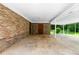 Spacious carport with brick wall and concrete floor, offering covered parking and storage at 501 Samaritan Dr, Cumming, GA 30040