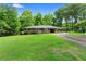 Charming single-story home with a well-manicured lawn, mature trees, and covered carport at 501 Samaritan Dr, Cumming, GA 30040