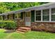 Charming brick home with green shutters, landscaped yard and inviting front entrance at 501 Samaritan Dr, Cumming, GA 30040