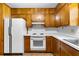 Efficient kitchen with wood cabinets and standard appliances at 501 Samaritan Dr, Cumming, GA 30040