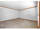 Carpeted living room with wood trim and white walls, offering a blank canvas for personalization at 501 Samaritan Dr, Cumming, GA 30040