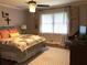 Bright bedroom with a decorative ceiling fan and a large window with bright light coming through at 747 Dogwood Cir, Norcross, GA 30071