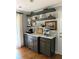 Coffee bar area with gray cabinets, open shelving, and countertop appliances at 747 Dogwood Cir, Norcross, GA 30071