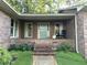 Inviting front porch with rocking chair and well-maintained landscaping at 747 Dogwood Cir, Norcross, GA 30071